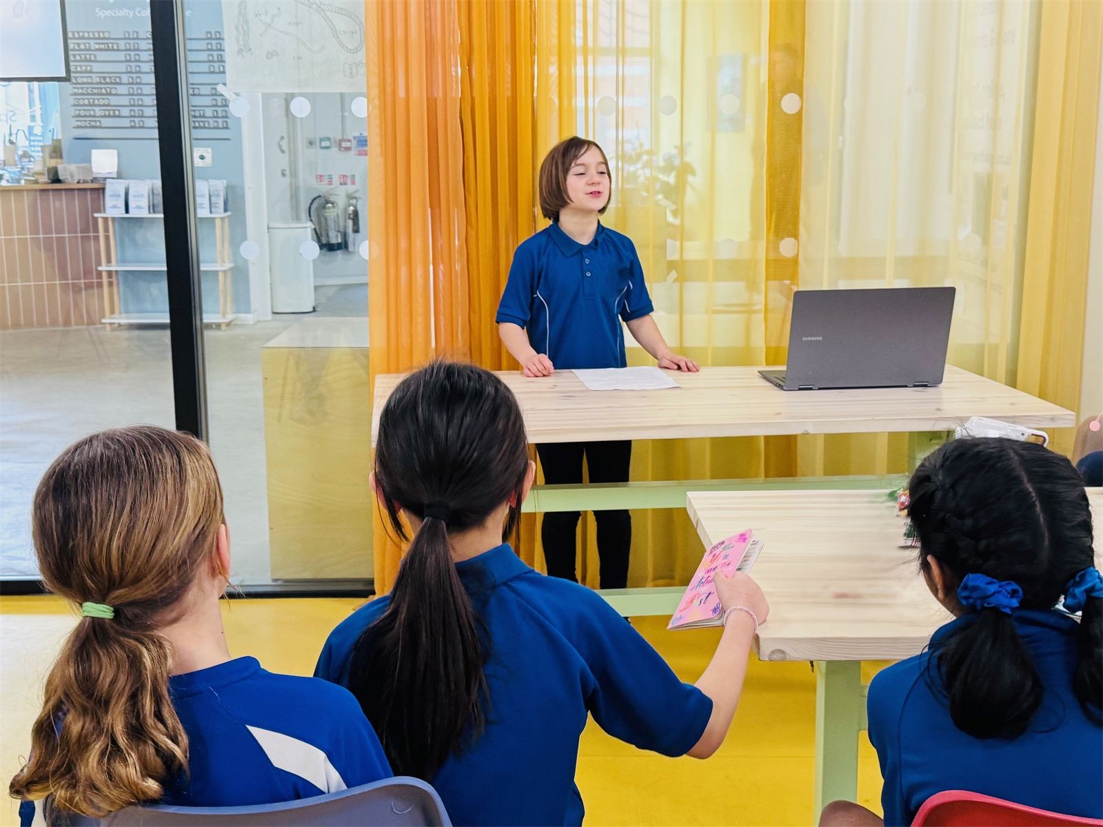 A child presenting to other children at a Configur Academy session